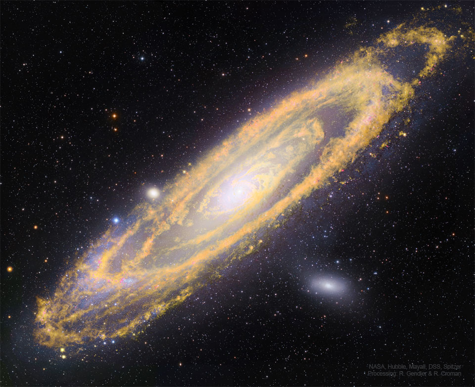 这幅特色图片显示了仙女座星系M31，在红外光下以橙色显示，在可见光下以白色和蓝色显示。请参阅说明以获取更多详细信息。